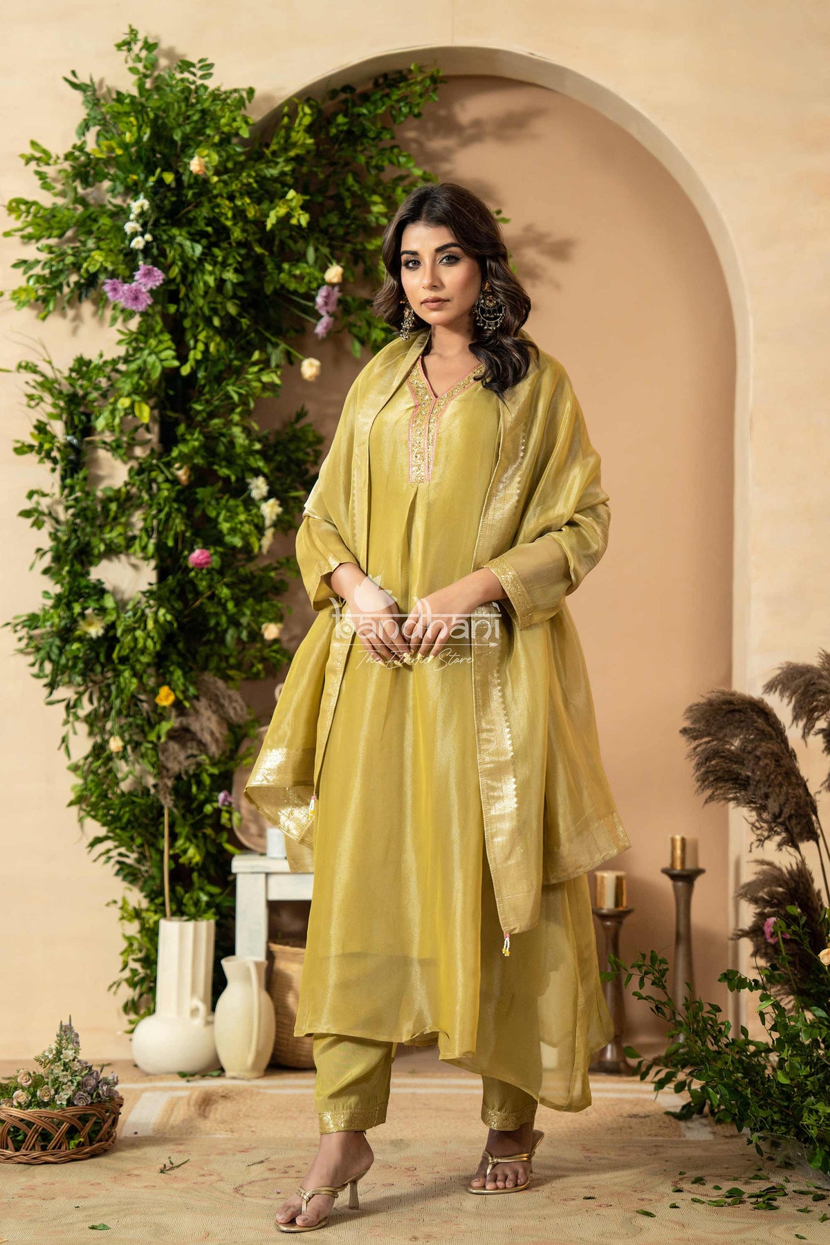 Woman in a green traditional outfit kurti pant dupatta set