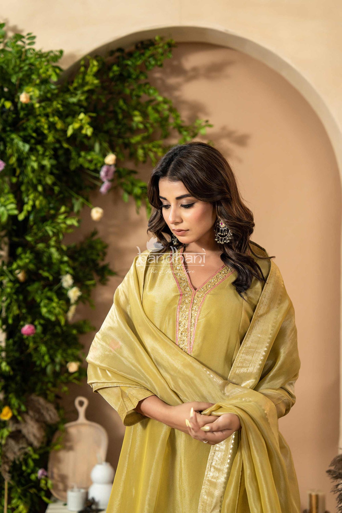 Woman in a light green traditional outfit kurti pant dupatta set