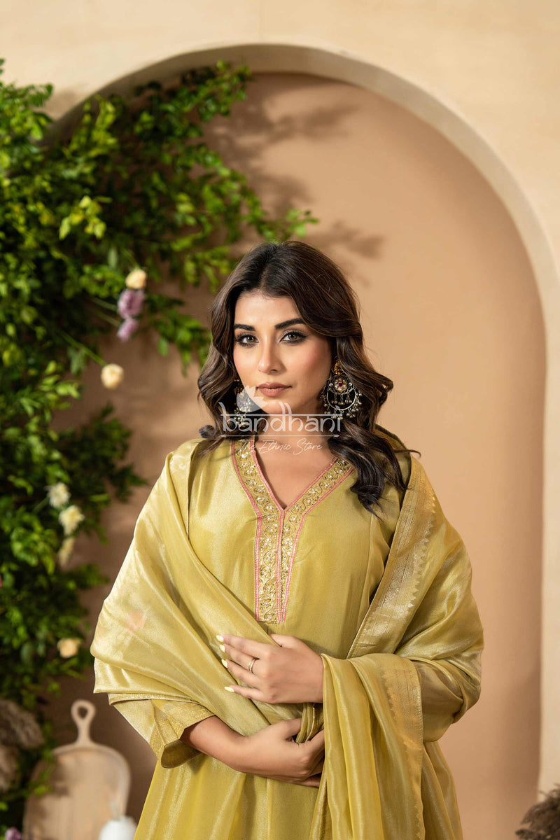 Woman in a green traditional outfit kurti pant dupatta set