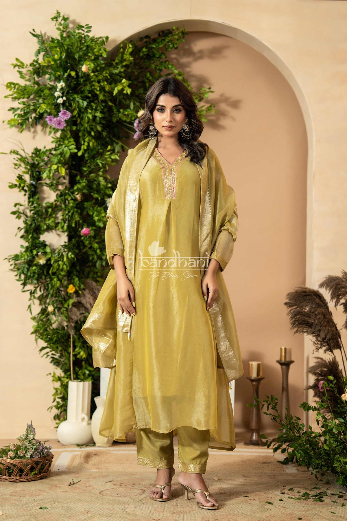 Woman in a green traditional kurti pant dupatta set