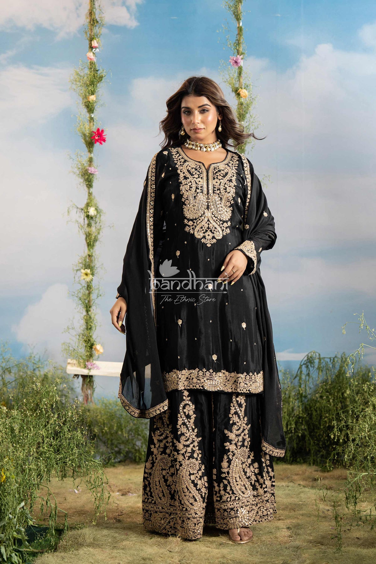 Woman in a black and gold traditional outfit with 'bandhan' branding against a scenic background.