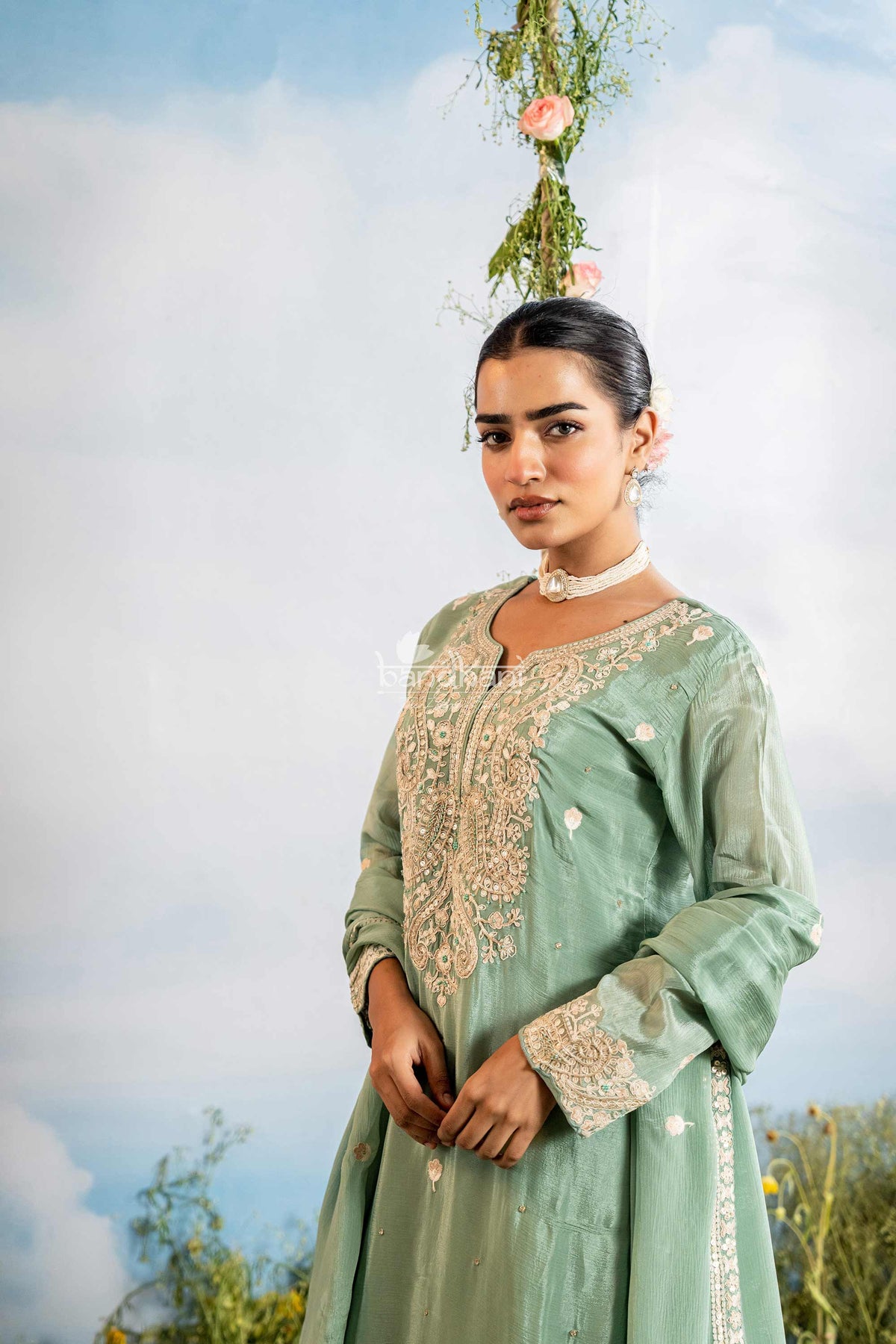 Woman in a light cardamom green traditional kurti pant dupatta set