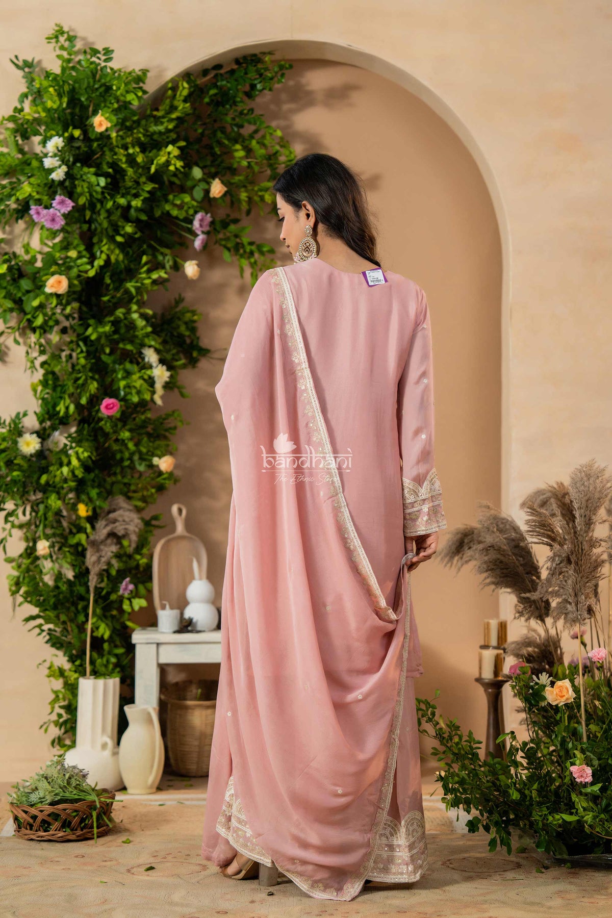 Woman in a pink kurti pant dupatta set