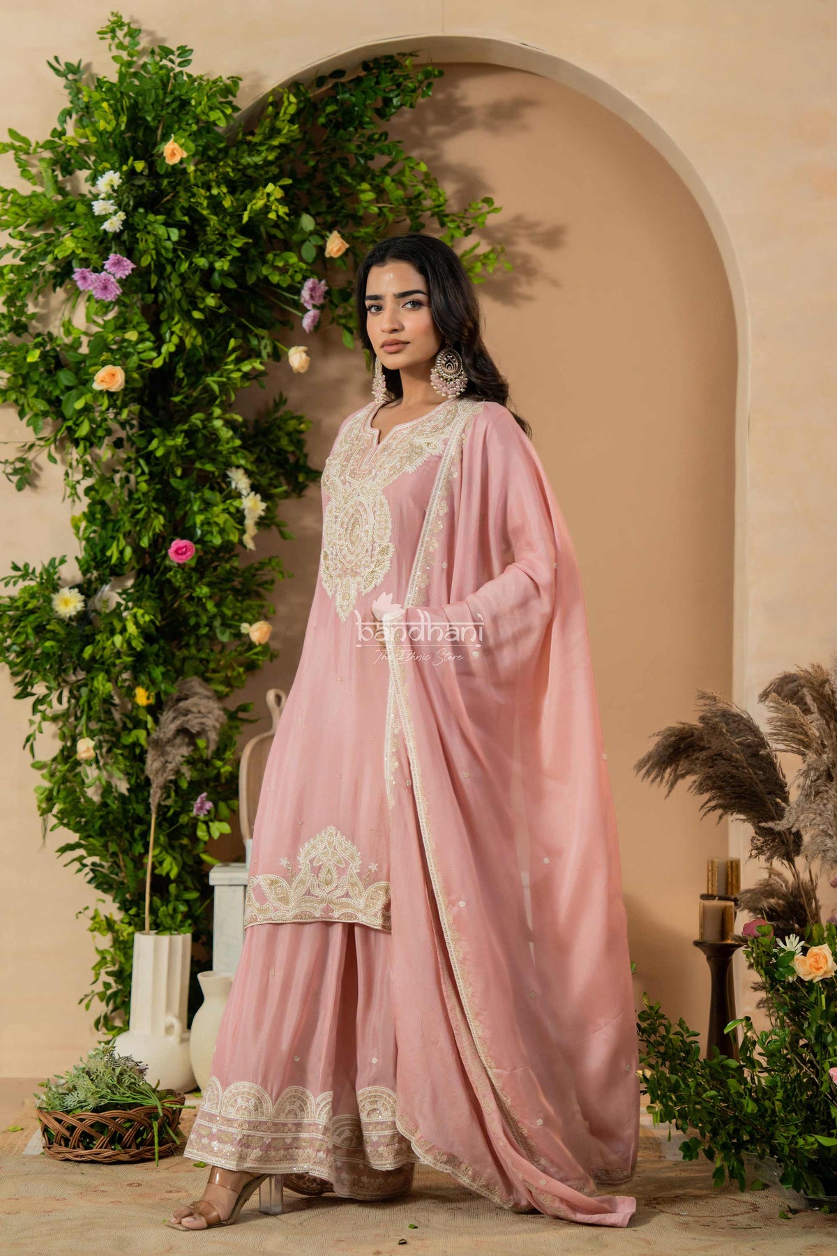 Woman in a pink traditional okurti pant dupatta set