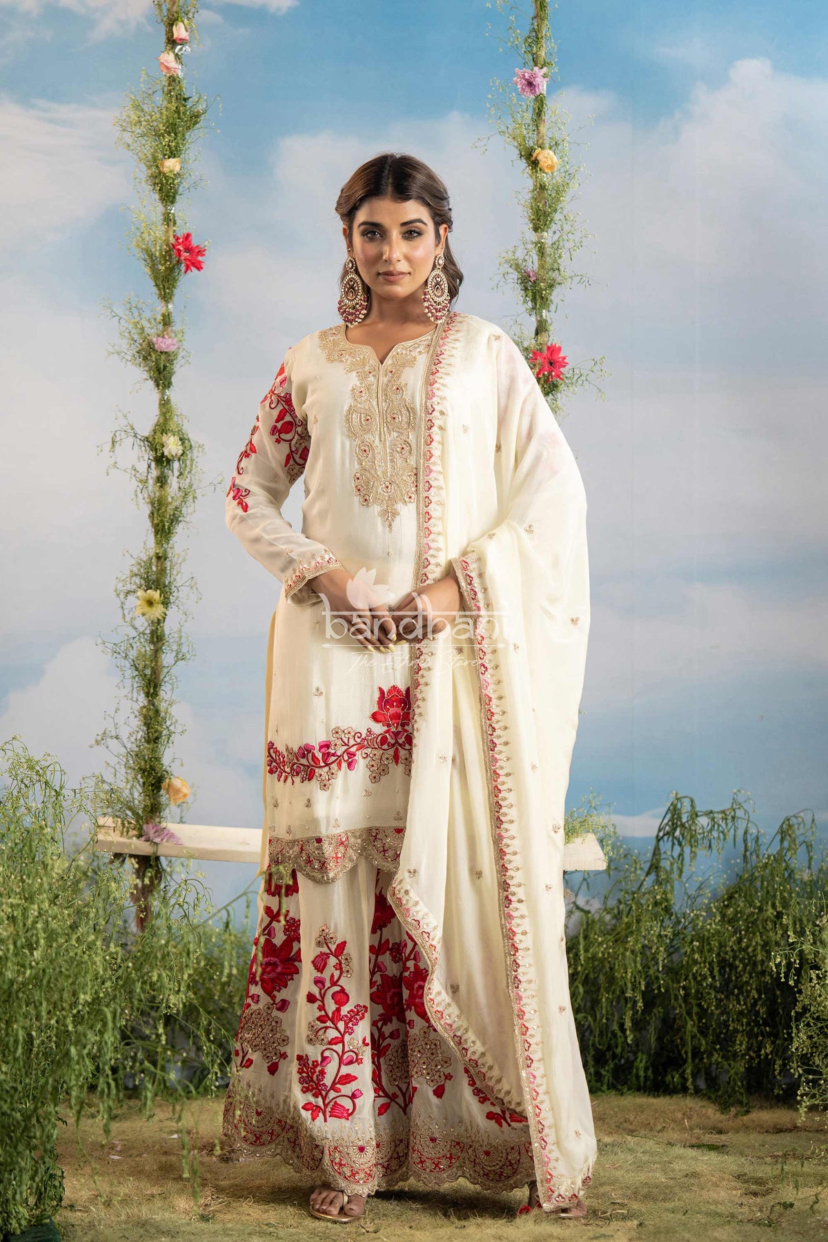 Woman in traditional embroidered outfit standing outdoors with a scenic background
