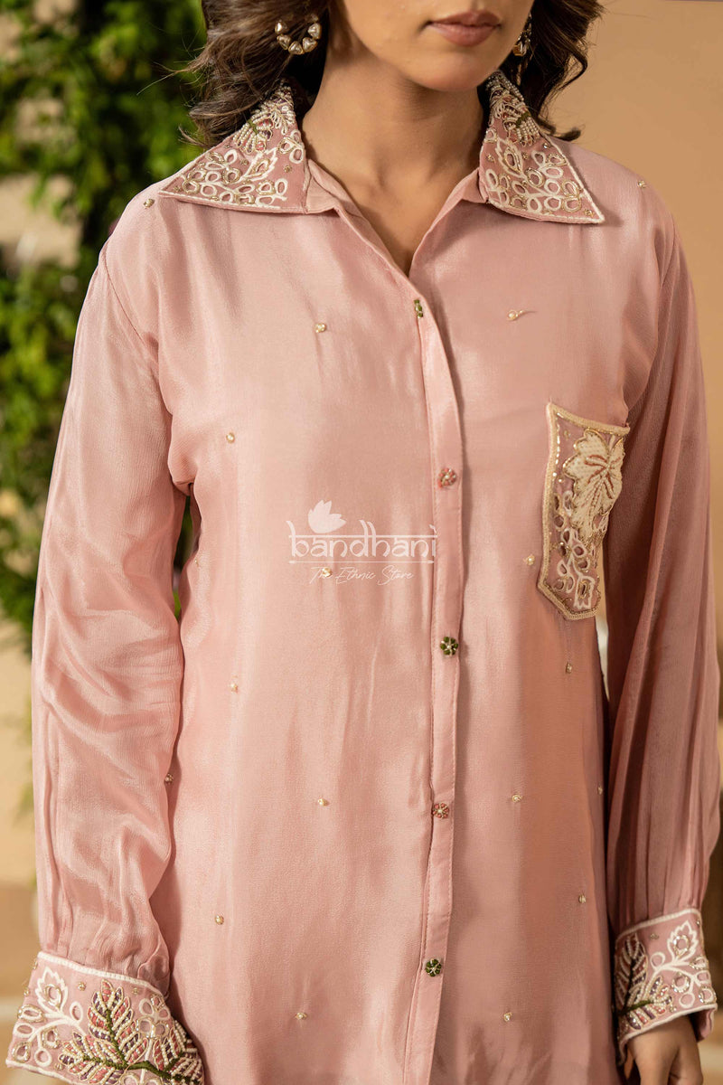 Pink embroidered shirt with 'bandhani' branding on a blurred background