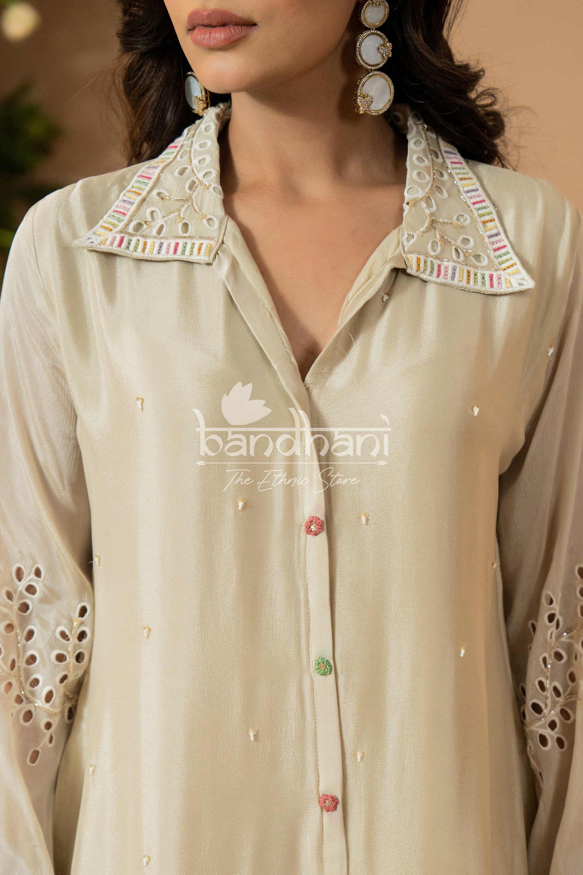 Beige shirt with intricate embroidery and 'bandhani' branding.