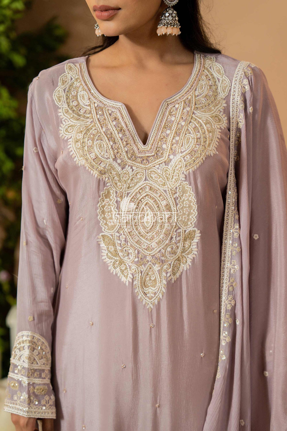 Light purple embroidered dress with intricate patterns on a blurred background