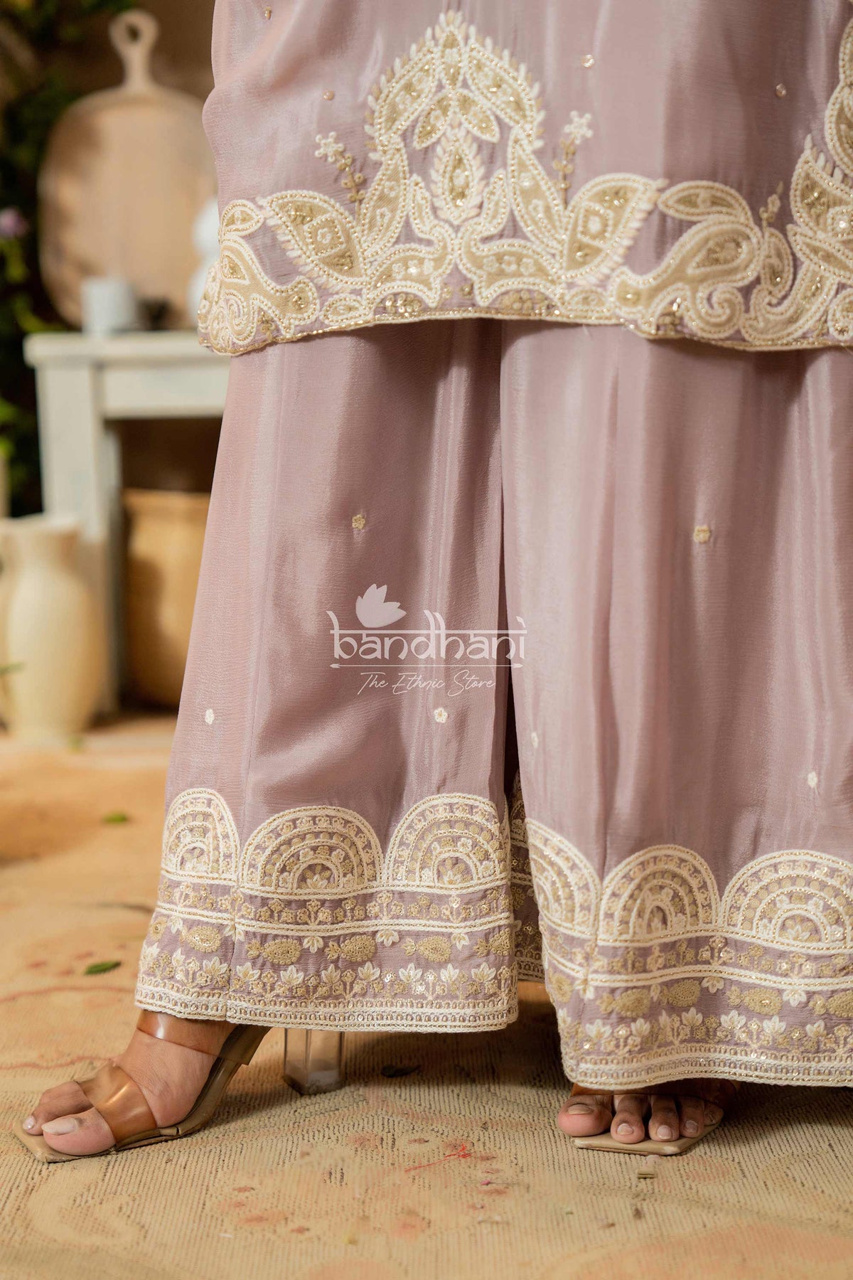 Mauve traditional outfit with gold embroidery, brand 'bandhani' visible.