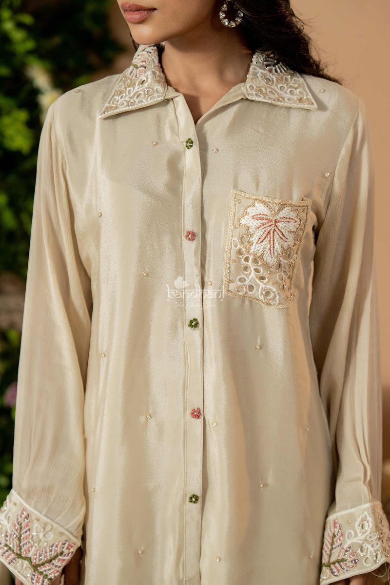 Beige shirt with intricate lace detailing on a blurred background