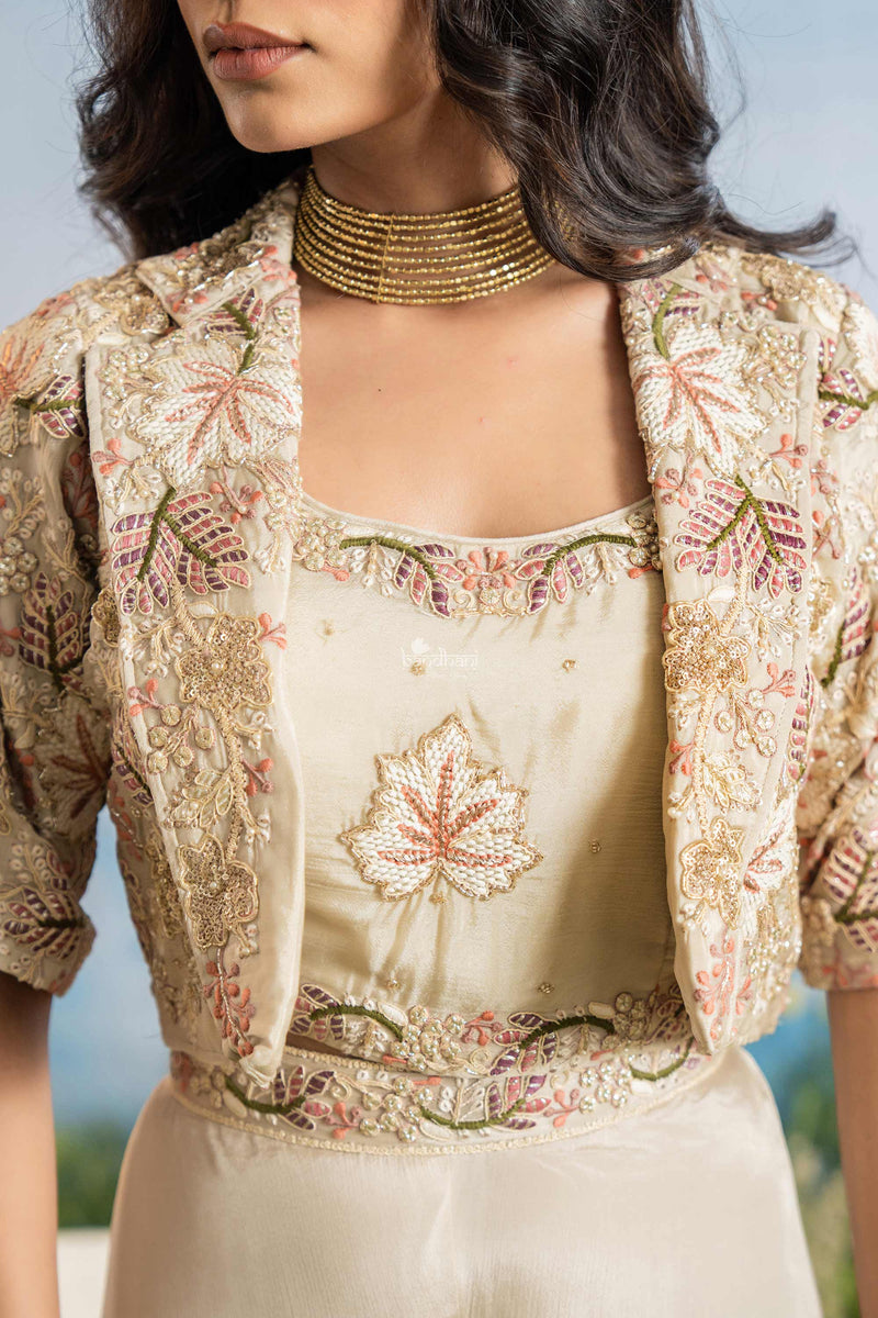 Woman wearing a traditional embroidered outfit with a floral pattern.