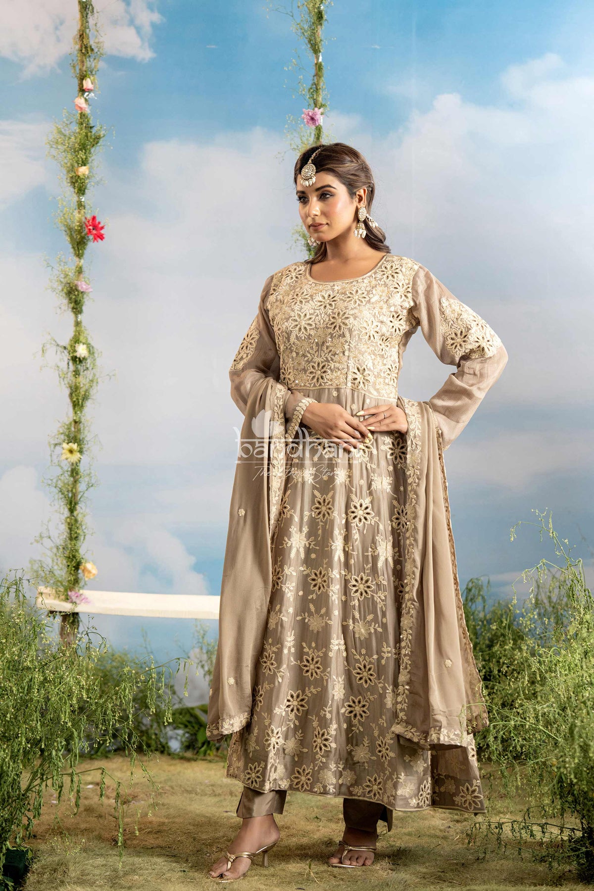 Woman in a traditional outfit standing outdoors with a scenic background
