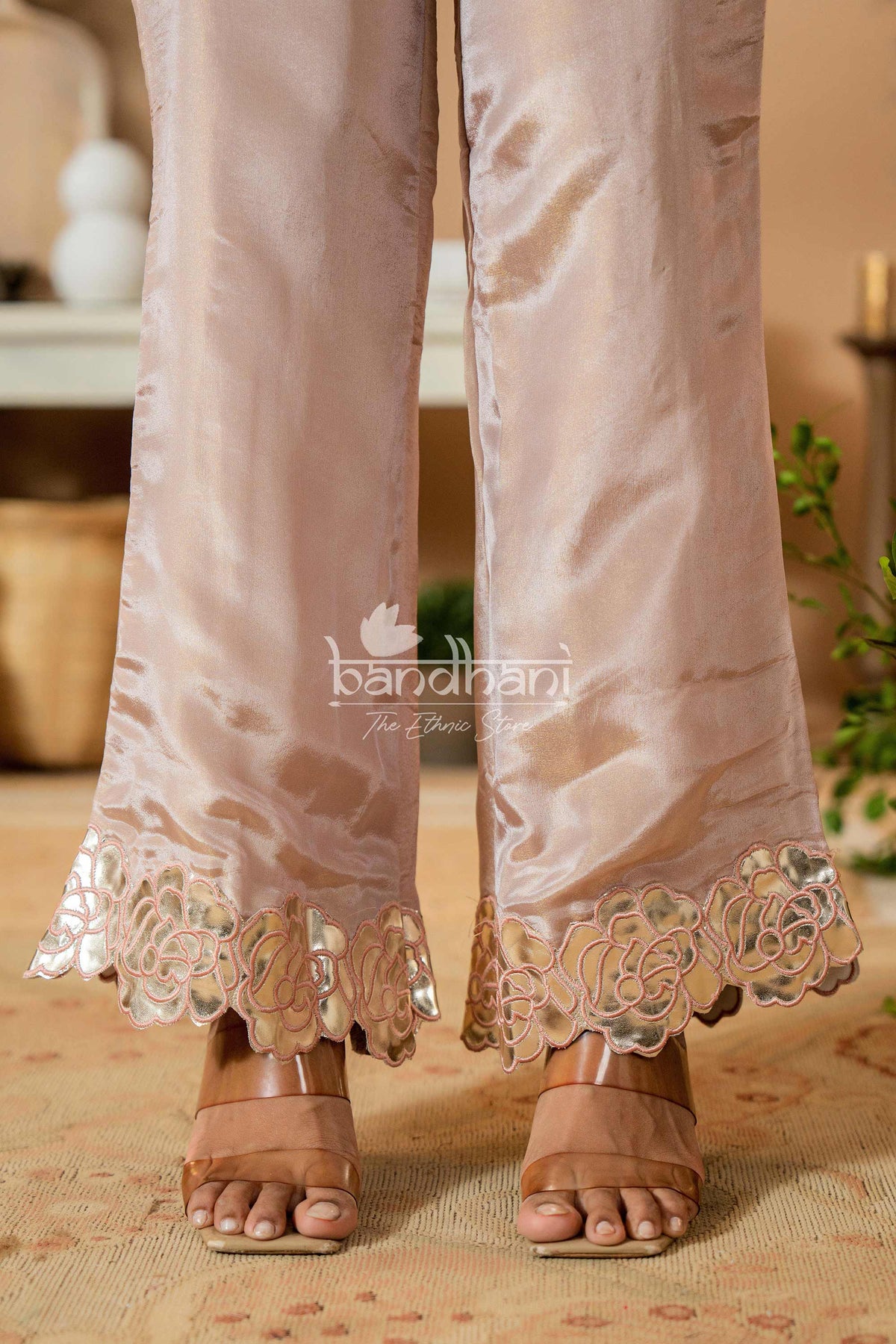 Light pink pants with lace detailing worn by a person, with 'bandhani' brand visible.