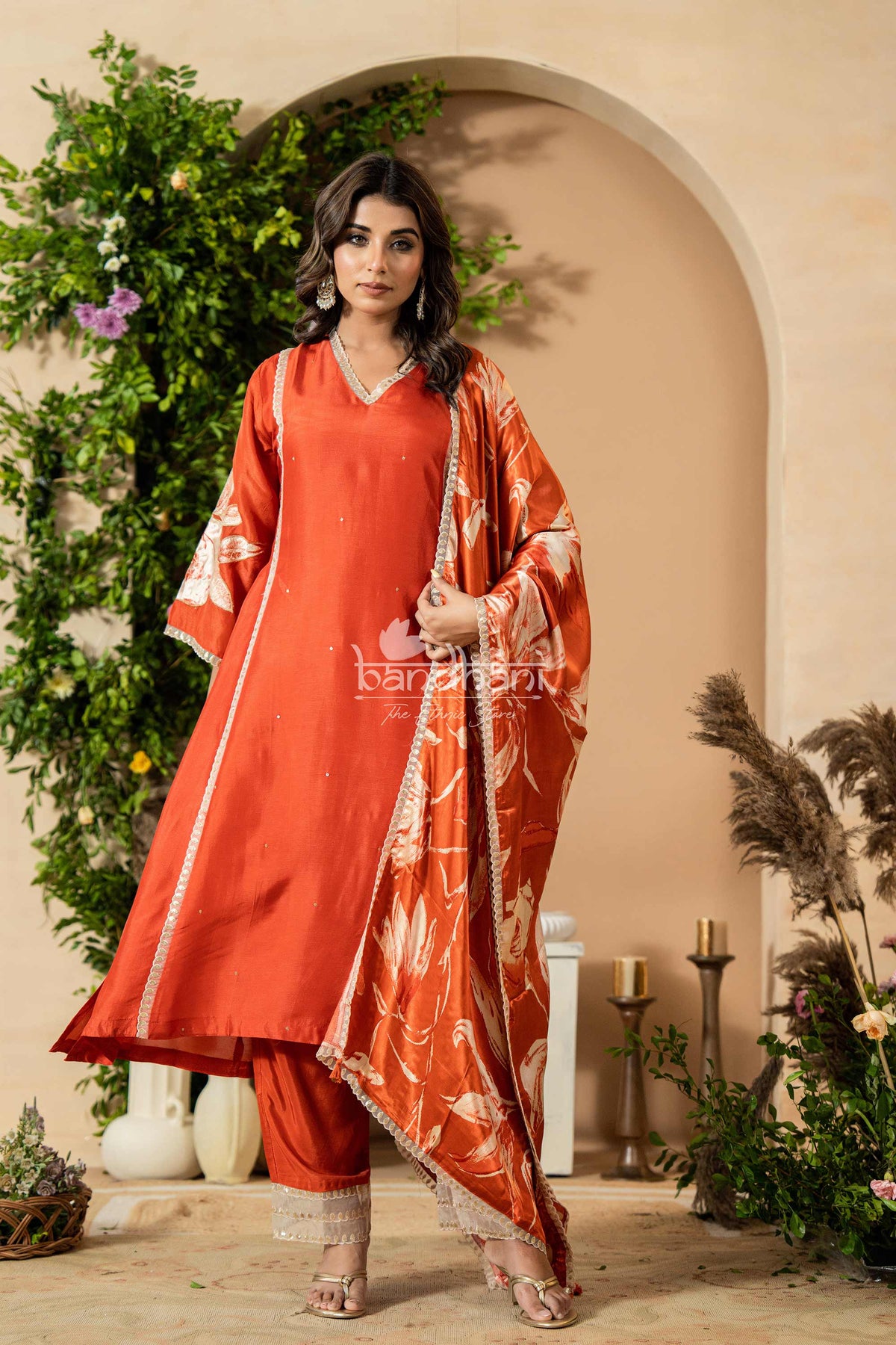 Woman in a traditional outfit with a decorative background