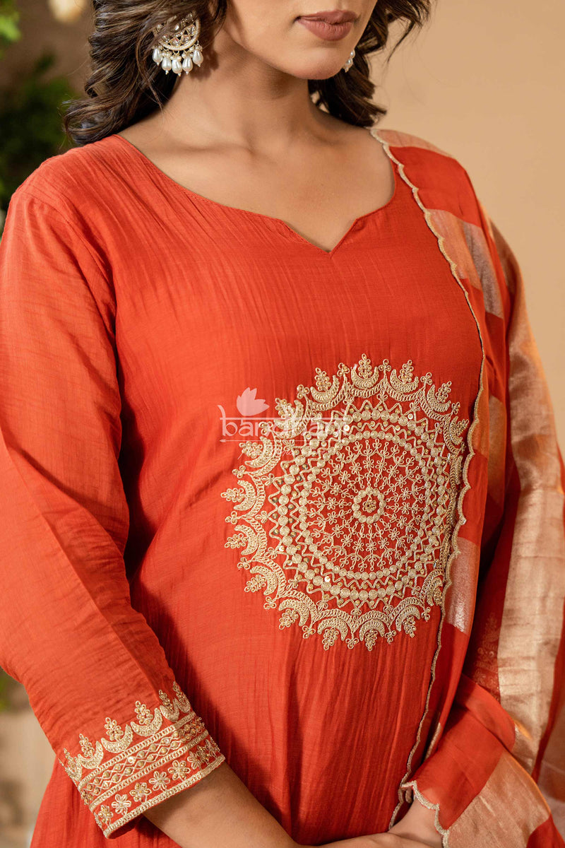 Red kurta with intricate white embroidery on a neutral background