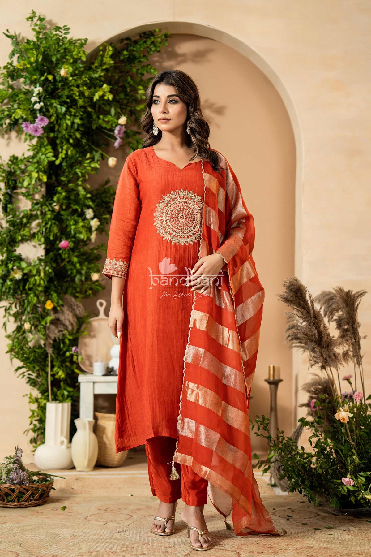 Woman in a red traditional outfit with a floral background