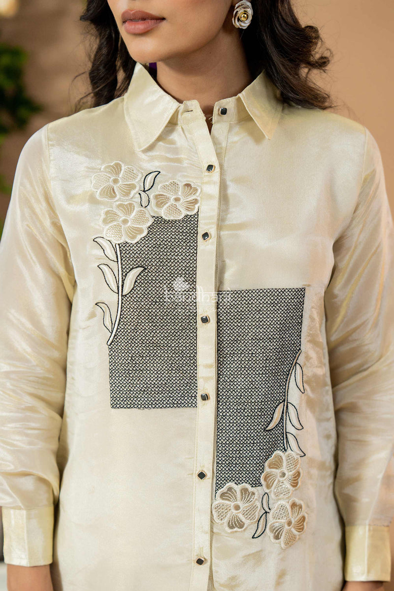 Beige shirt with floral embroidery and a geometric pattern on a beige background