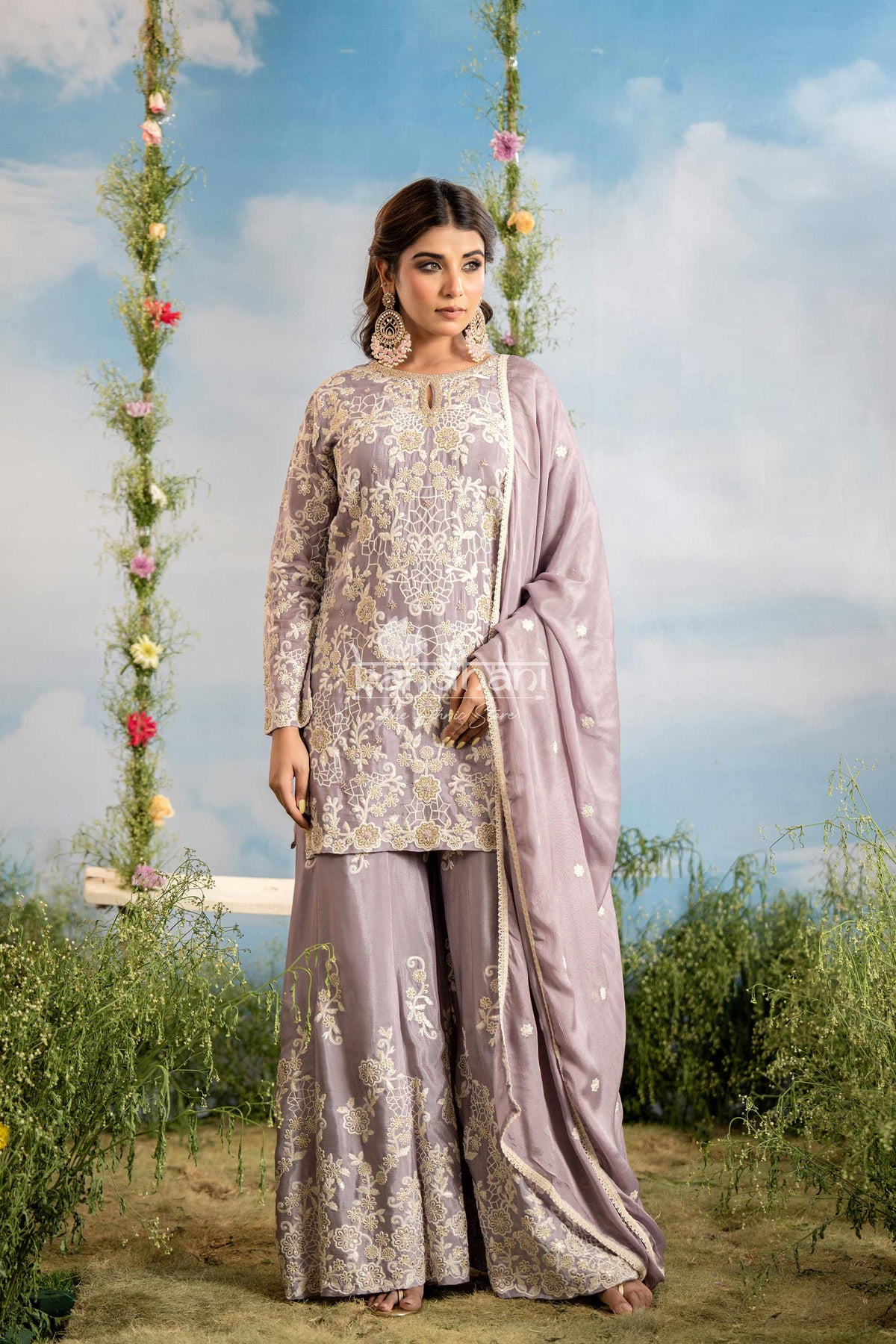Woman in traditional outfit with floral decorations and sky background