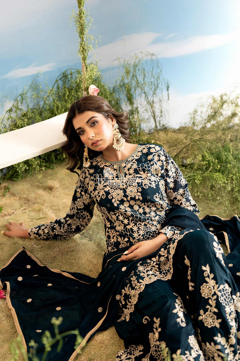 Woman in a floral dress sitting outdoors with a scenic background