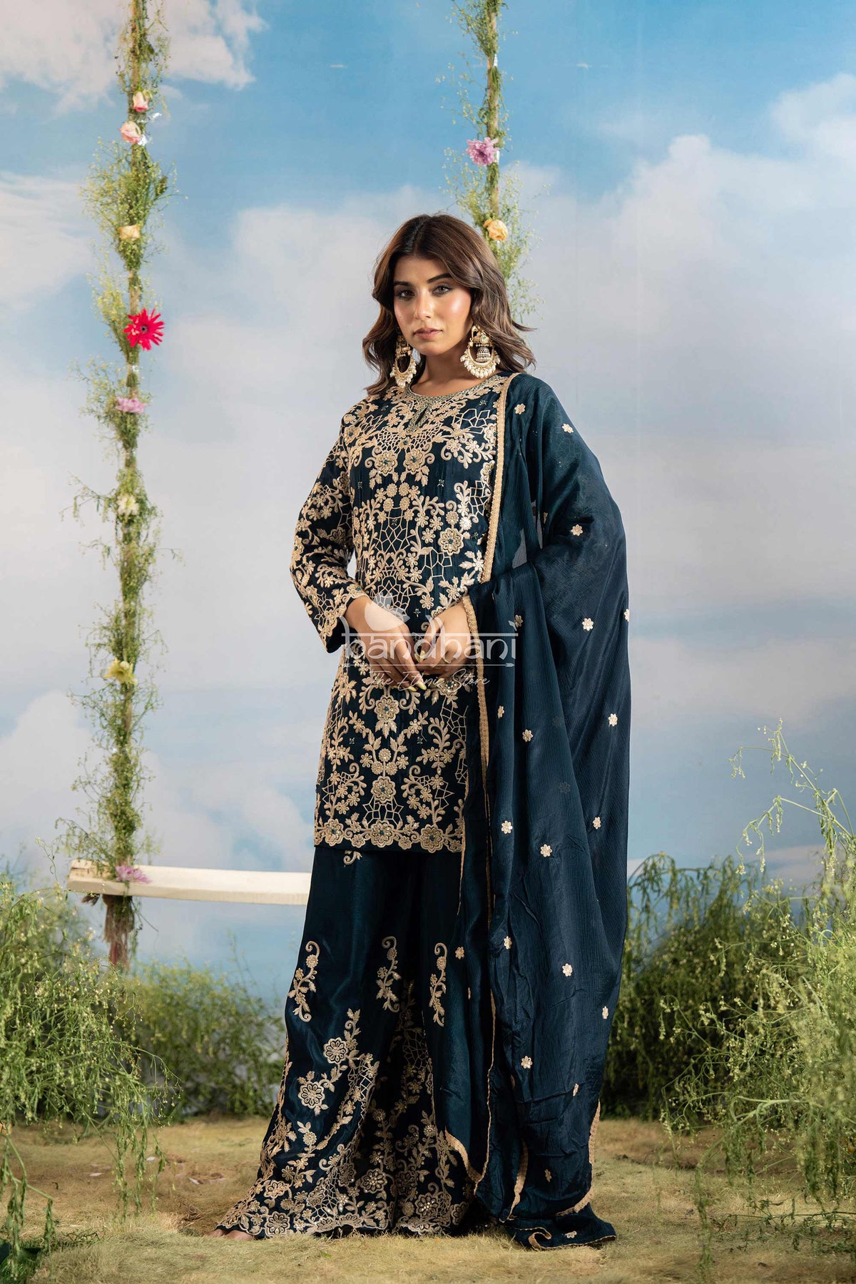 Woman in a traditional outfit with floral patterns against a natural background